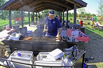MINOT AIR FORCE BASE, N.D. -- Master Sgt. Ronald Tolzin, 5th Operations Support Squadron first sergeant, was the unit’s grillmaster during the squadron picnic held Aug. 15 at Bud Ebert Park here. Food and fun were plentiful throughout the day. (U.S. Air Force photo by Airman 1st Class Benjamin Stratton)