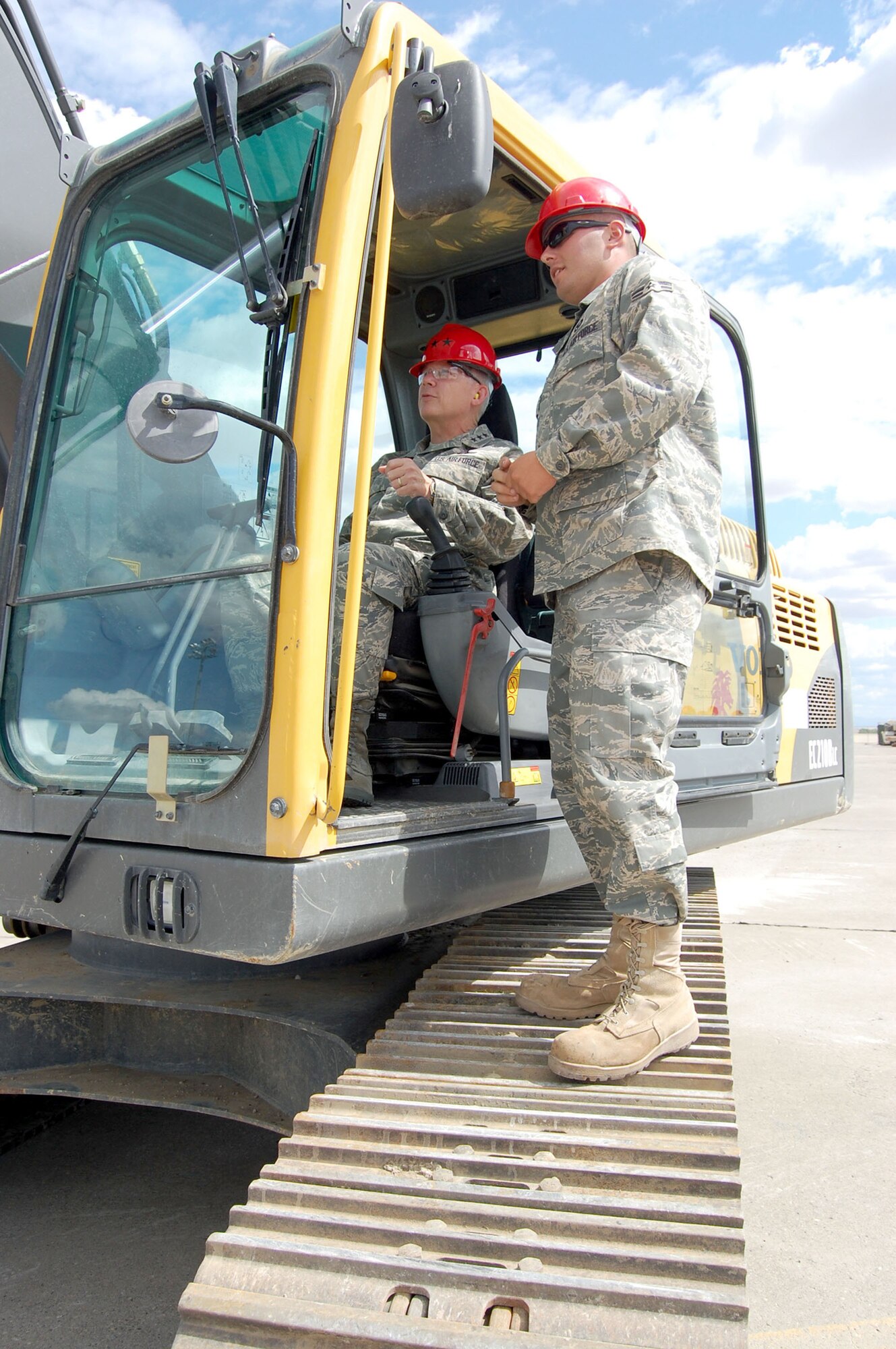 Lt. Gen. Robert Elder, 8th Air Force commander, learns how to pulverize and tear up concrete in an excavator from Airman 1st Class Brandon Lynch, 819th RED HORSE Squadron, during a ground breaking ceremony at Malmstrom Air Force Base, Mont., Aug. 14. The 819th RHS is tearing up a 20,000 square foot area to build a unit assembly area; a $678,000 construction project slated to be completed by March 2009 and built entirely by the squadron. General Elder and Maj. Gen. Floyd Carpenter, 8th AF vice commander, both participated in the ground breaking ceremony. (U.S. Air Force photo/Senior Airman Eydie Sakura).  
