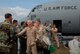 Col. Mark Kraus, commander of the 123rd Airlift Wing, is greeted as he deboards here.(Staff Sgt. Diane Stinnett/KyANG)
