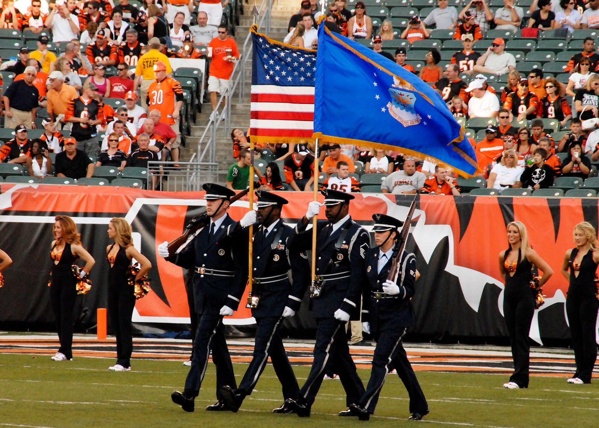 U.S. Air Force Airman 1st Class Brandon Mitchell, Master Sgt. Mark Lyle, Master Sgt. Michael Bailey, and Senior Airman Jeanice Smith march the colors down the field for the opening ceremony at the Bengals vs. Lions football game at Paul Brown Stadium located in Cincinnati, Ohio, on August 17, 2008.  The Honor Guard is dedicated to supporting the ceremonial needs of the 445th Airlift Wing and the greater Miami Valley communities by proudly performing as professional representatives of the United States Air Force. (U.S. Air Force photo by Senior Airman Ken LaRock)