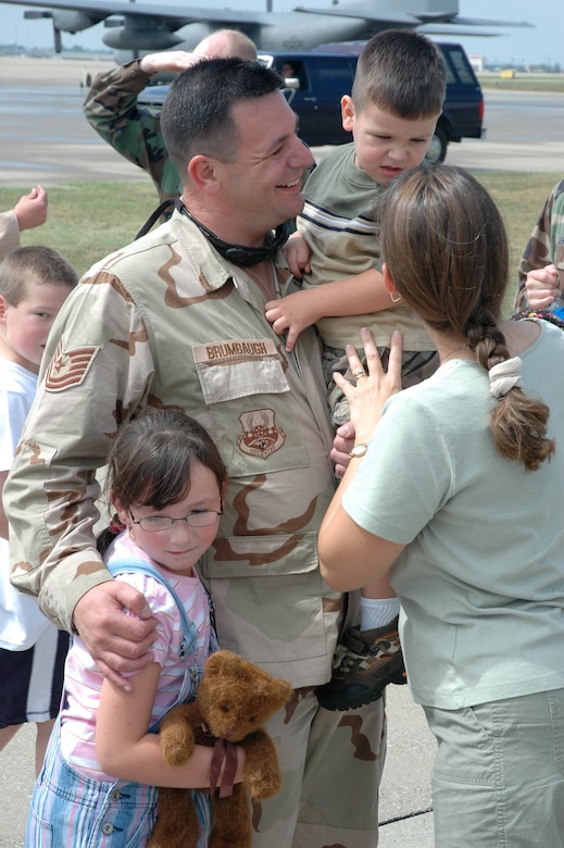 Tech. Sgt. Delbert Brumbaugh is greeted by his family on the tarmac. Sergeant Brumbaugh is a life support technician in the 165th Airlift Squadron here. (Capt. Dale Greer/KyANG)