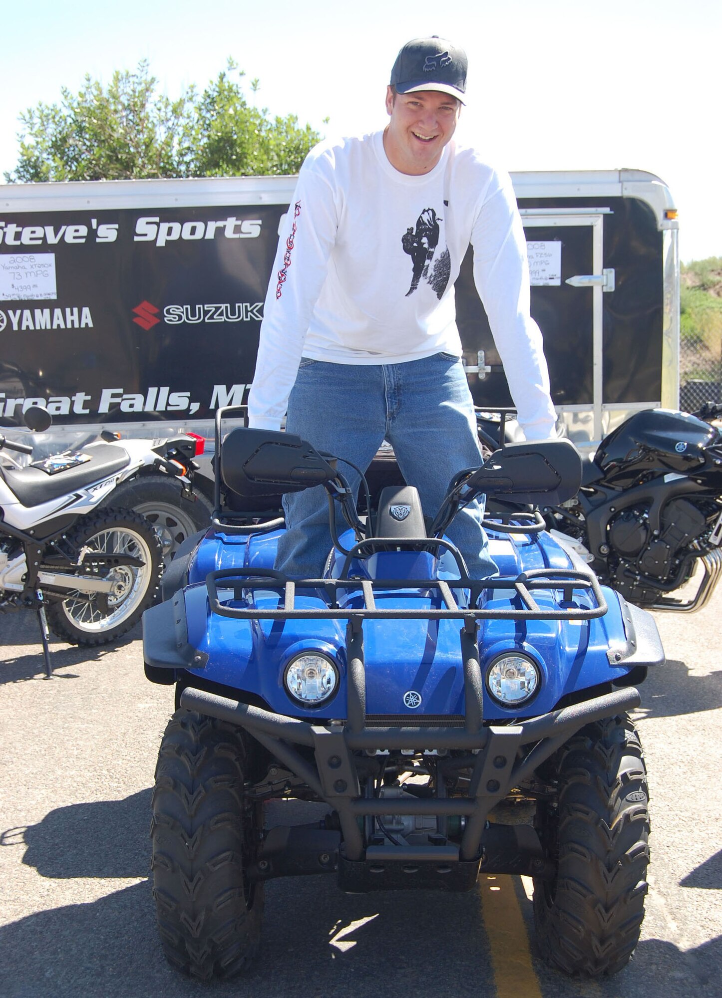Airman 1st Class Alex Holmes, 741st Missile Security Forces Squadron mobile fire team member, wins a free four-wheeler at the base picnic Aug. 15.  Several thousand people filled Sun Plaza Park at Malmstrom Air Force Base for the wing’s annual summer picnic. Servicemembers and their families enjoyed free food, music, games, a car show, giveaways, bouncy castles and much more. (U.S. Air Force photo/Senior Airman Eydie Sakura).