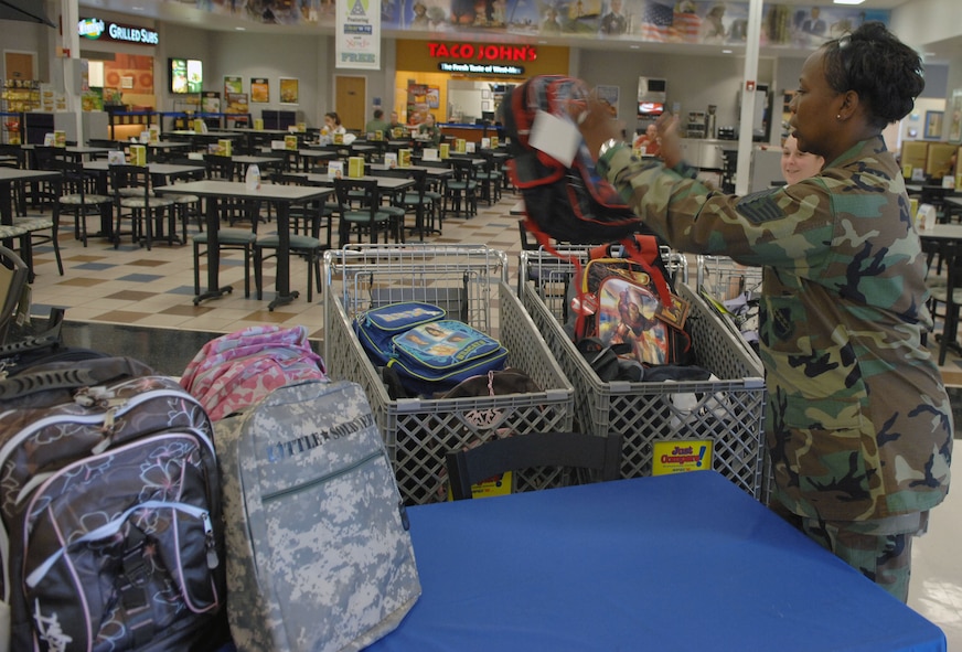 DYESS AIR FORCE BASE, Texas -- Tech. Sgt. Yolanda Hands, President of the 56 Club, organizes donated backpacks filled with school supplies during the 56 Club's school supply drive at the Base Exchange here, Aug. 18.  The 56 Club consists of staff and technical sergeants who volunteer time to support the local community, on and off base.  The school supply drive, "Airmen for AISD" (Abilene Independent School District), was designed to provide school supplies to children from less fortunate families, ensuring they have the required supplies for the school year while emphasizing in the importance of educating youth. (U.S. Air Force photo by Staff Sergeant Connor Estes)        