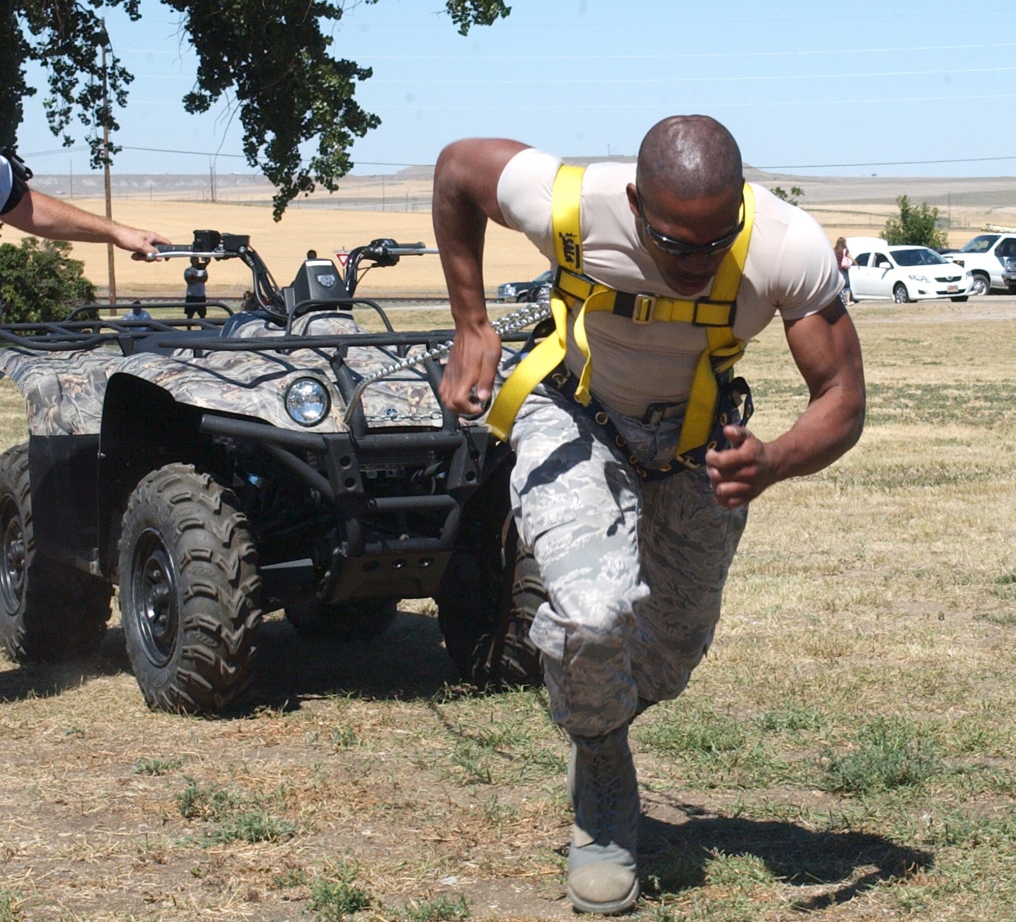 Capt. Jahrod Matlock, strains to reach the finish line in the "ATV Pull" portion of the Grizzly Challenge strength competition at the Malmstrom Air Force Base Picnic Aug. 15.  Competitors pulled a full-size four-wheel all-terrain-vehicle 80 feet and were scored on how fast they covered the distance.  Capt. Matlocki is a operations officer for the 341st Security Support Squadron and was the overall winner of the Grizzly Challenge, as well as the winner of the Middleweight Division.  (U.S. Air Force photo/Maj. David Kurle)                                                     