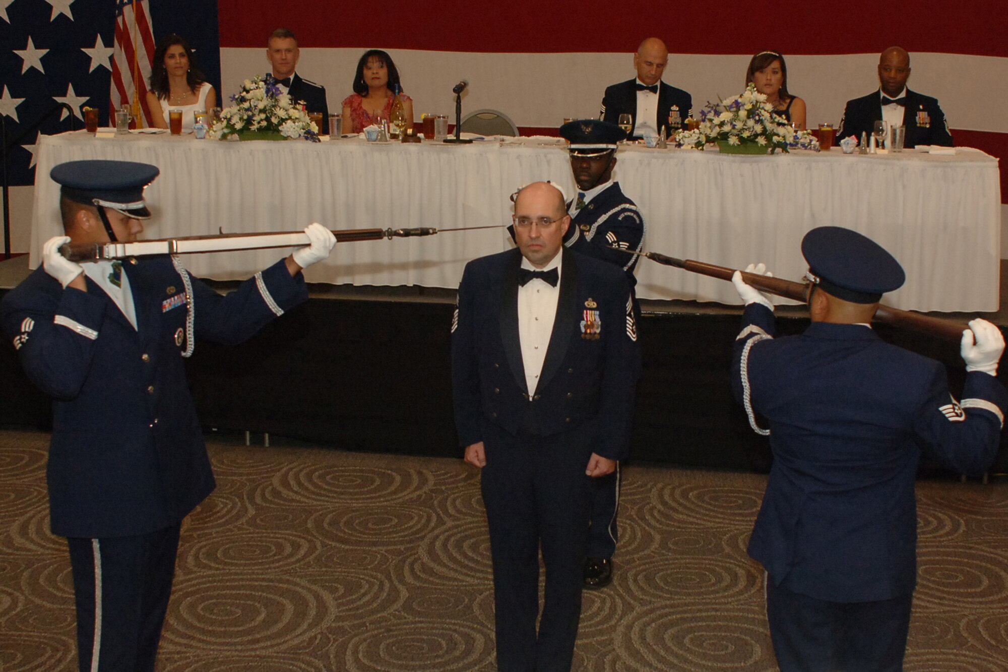 DYESS AIR FORCE BASE Texas--Command Chief Master Sgt. David Goldie, 7th Bomb Wing command chief, along with members of the Dyess Honor Guard, entertain the members of the mess at the 25th annual Enlisted Dining Out at the Abilene Civic Center August 15. The Enlisted Dining Out is held annually to boost morale and give Air Force members a chance to build camaraderie in a stress-free environment.(U.S. Air Force photo/ Senior Airman Felicia Juenke)