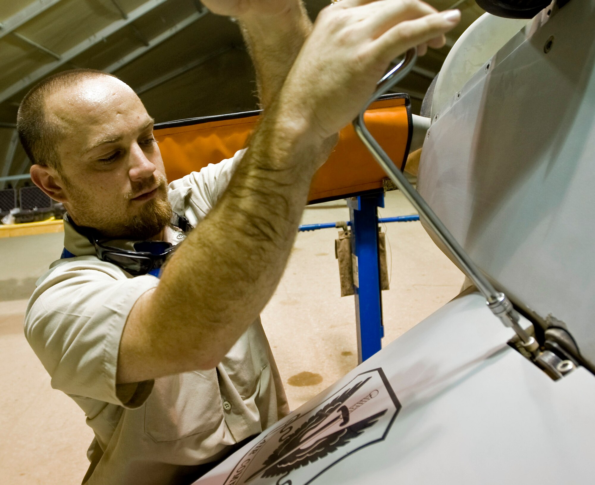 Antonio McEver performs post-flight maintenance on an MQ-1 Predator Aug. 11 at Ali Base, Iraq. The Predator is a medium-altitude, long-endurance remotely piloted aircraft designed to interdict and conduct armed reconnaissance against critical and perishable targets. Mr. McEver is assigned to the 46th Expeditionary Reconnaissance and Attack Squadron Det. 1 here. (U.S. Air Force photo/Airman 1st Class Christopher Griffin) 
