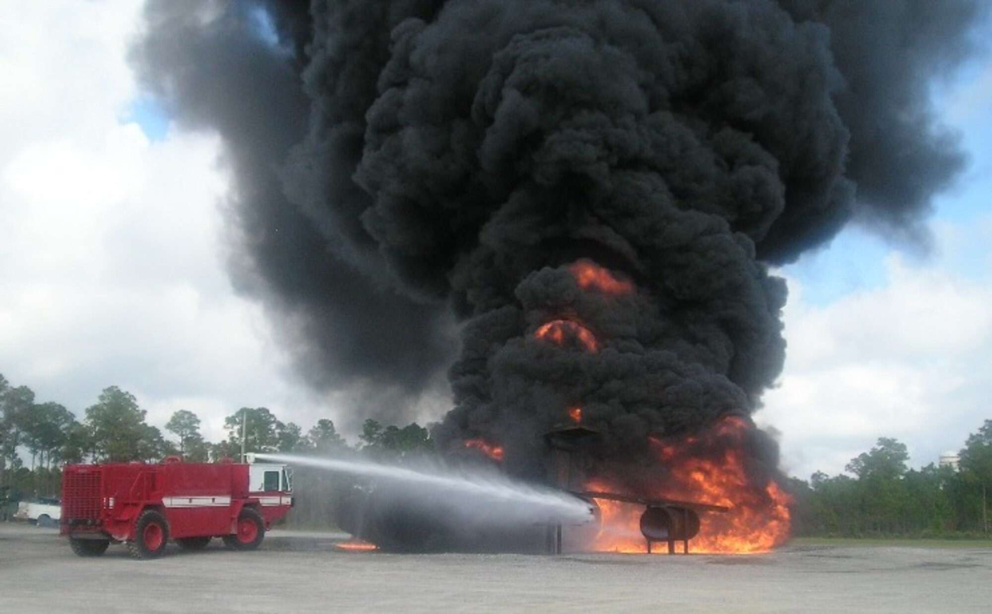 Firefighters extinguish a blaze on a simulated fighter aircraft at Tyndall Air Force Base, Fla. (Photo courtesy 123rd Civil Engineering Squadron)