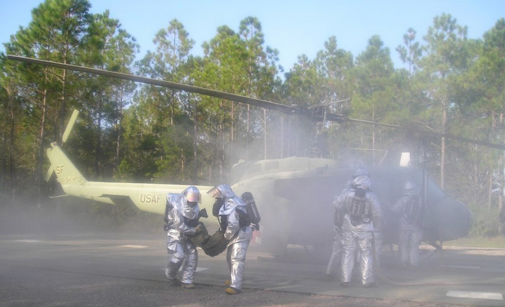 Firefighters from the Kentucky Air Guard’s 123rd Civil Engineering Squadron practice
extracting wounded aircrew members from a smoking helicopter during Silver Flag 2006, held at Tyndall Air Force Base, Fla., from Oct. 14 to 21. (Photo courtesy 123rd Civil Engineering Squadron)
