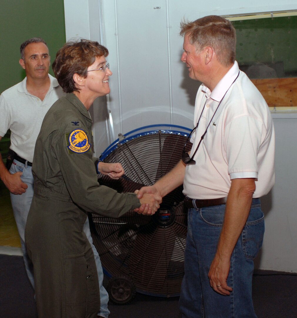 Col. Jacqueline Van Ovost, 12th Flying Training Wing commander, talks with John McKinley, 12th Mission Support Group Logistics Readiness Division, during the grand opening ceremonies at the new Deployment Processing Center Aug. 14. (U.S. Air Force photo by Steve White)