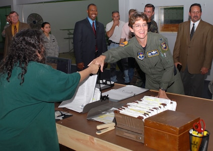 Col. Jacqueline Van Ovost, 12th Flying Training Wing commander, talks with Kezia Hillary, 12th Mission Support Group Logistics Readiness Division, during the grand opening ceremony at the Deployment Processing Center Aug. 14. (U.S. Air Force photo by Steve White)