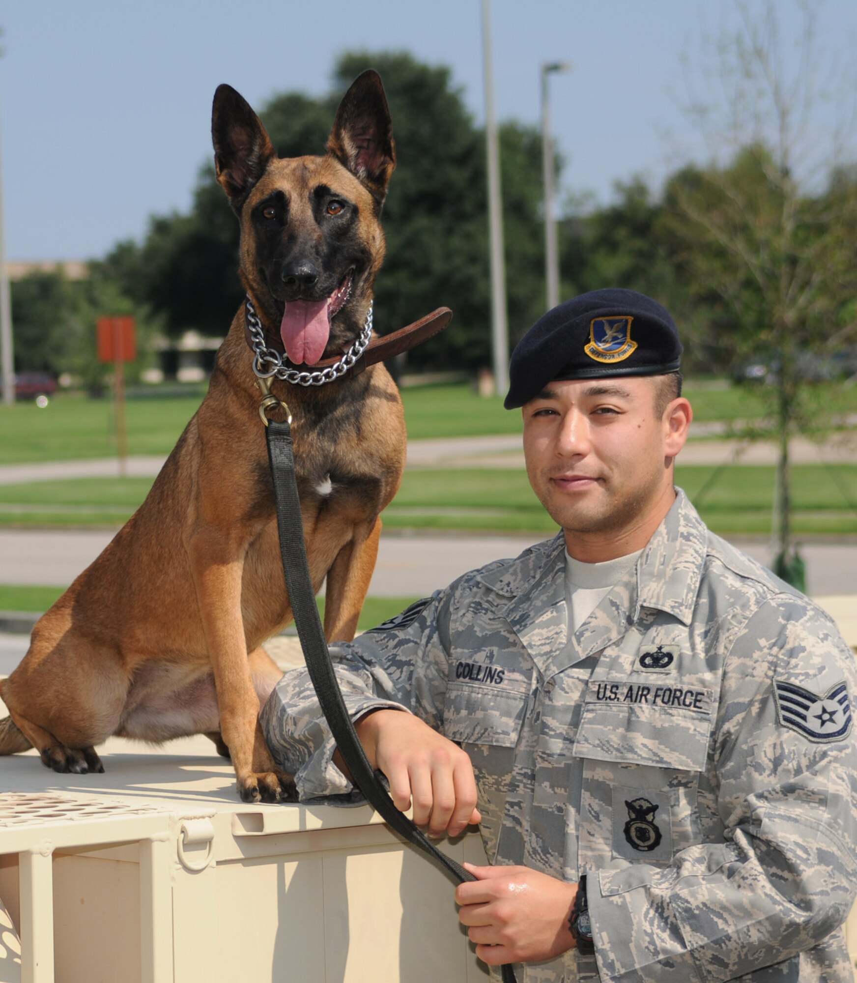 Right, Densy takes a break with her handler, Staff Sgt. Benjamin Collins.  (U.S,. Air Force photo by Kemberly Groue)
