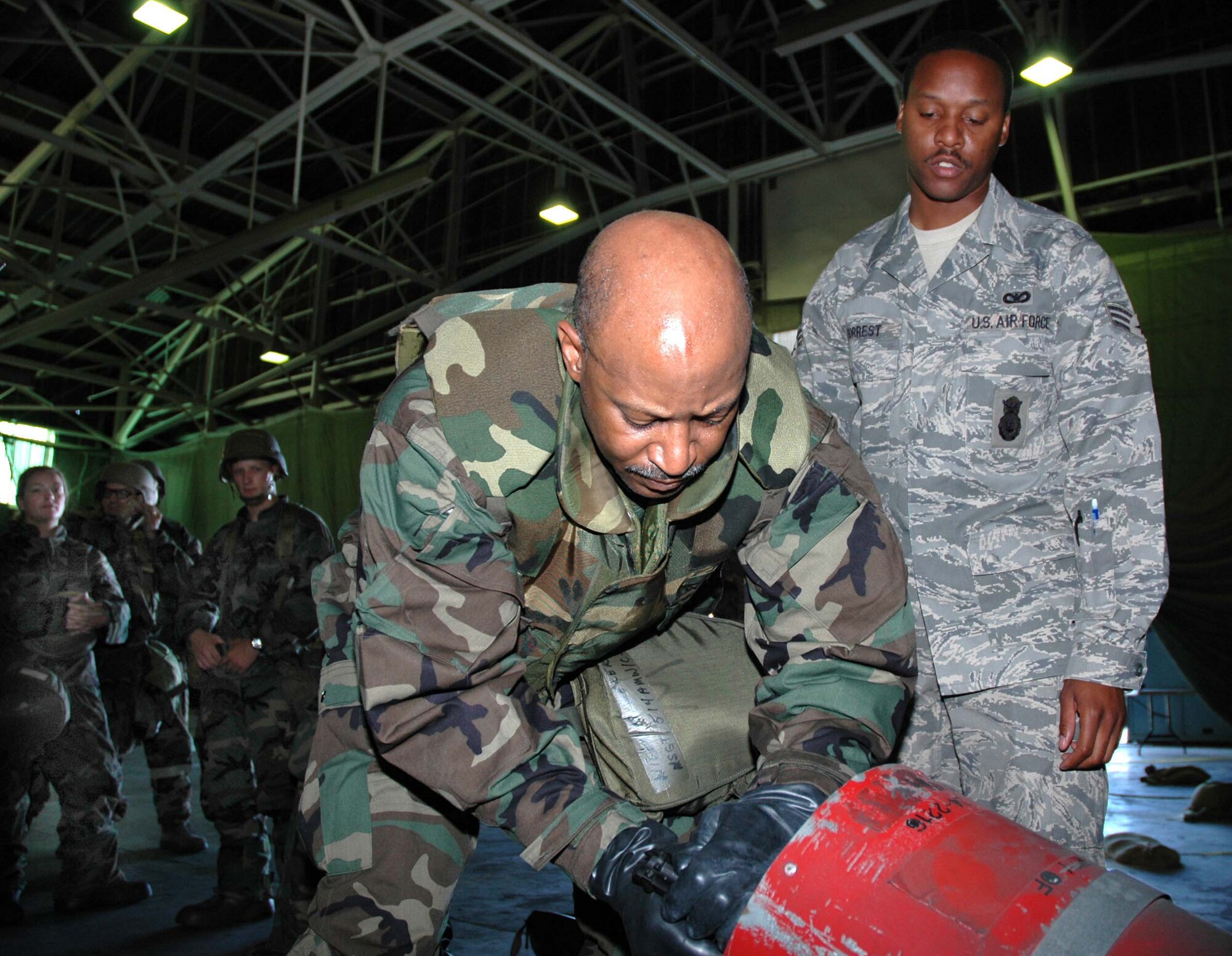 MCGUIRE AIR FORCE BASE, N.J. -- Senior Airmen Reginald Forrest an Air Force Reserve security forces member watches as Master Sgt. Derek Williams, a fellow reservists, clears an M-9 pistol during a recent Battle Axe training session.  Battle Axe is a half-day course designed to reinforce ability to survive and operate skills in a war environment. Preparation for the upcoming Operational Readiness Inspection includes sending ORI participants through the Battle Axe training facility.  (U.S. Air Force photo/Master Sgt. Charles W. Kramer) 