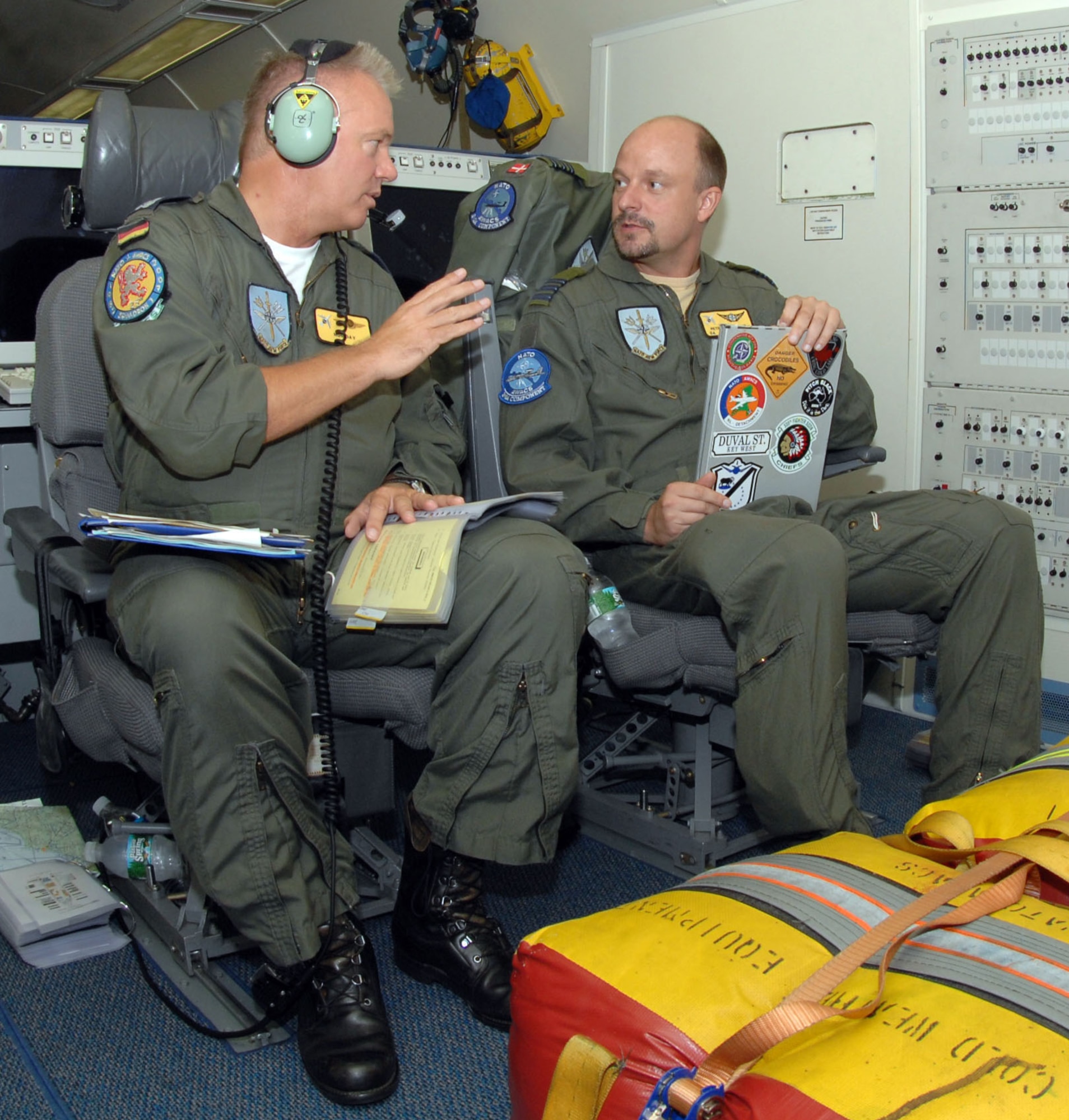 German Lt. Col. Raimond Schulz and Danish Maj. Peter Boersting, tactical directors, discuss pre-flight procedures on a E-3A Sentinel, an airborne warning and control systems aircraft from Geilenkirchen North Atlantic Treaty Organization Air Base, Germany  on August 15, 2008, Seymour Johnson Air Force Base, North Carolina. On the aircraft there are airmen from Turkey, Portugal, United States, Denmark, Germany, Greece and Canada. (U.S. Air Force photo by Airman 1st Class Gino Reyes)