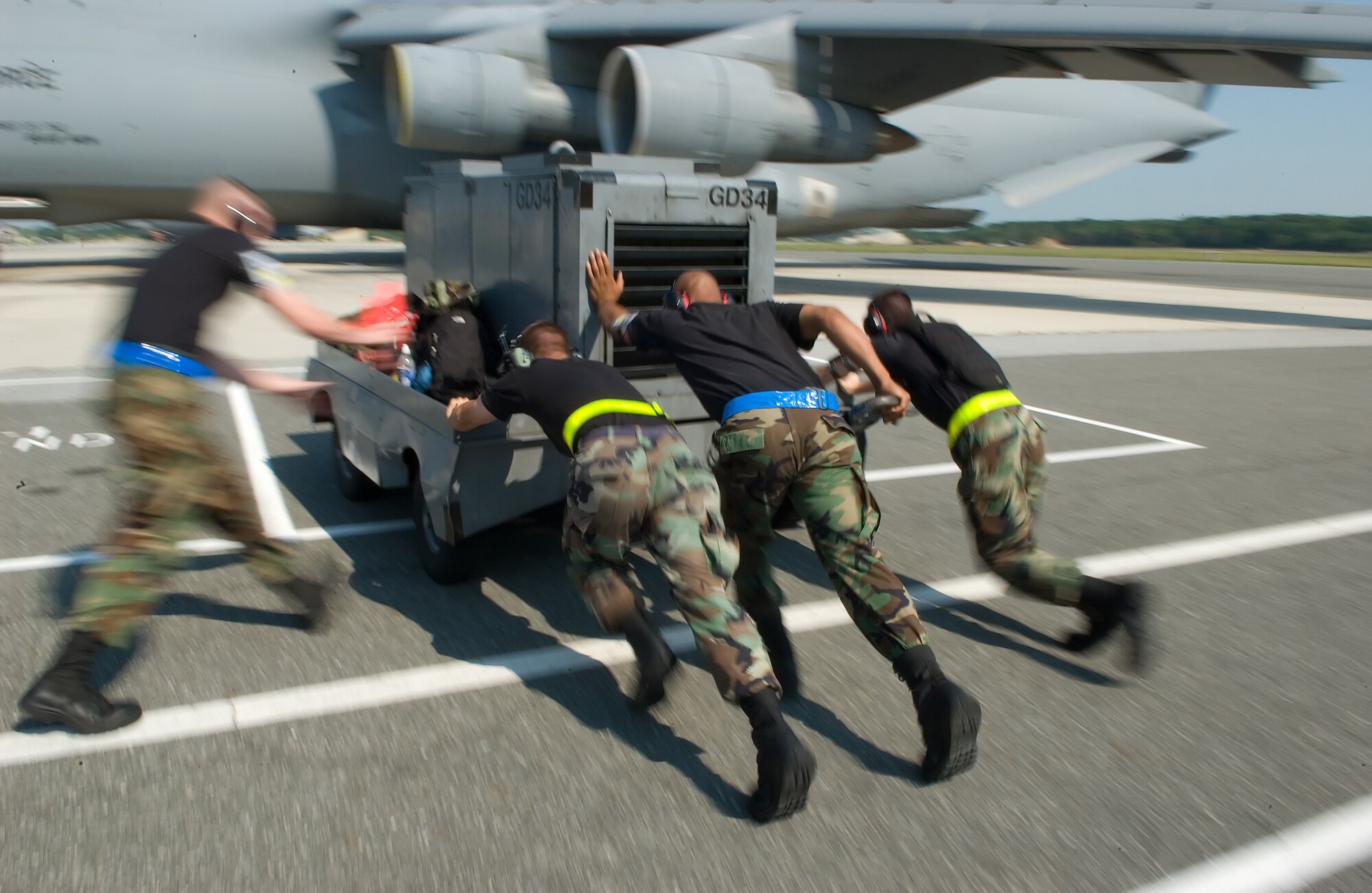 512th and 436th Airlift Wing Airmen push a generator into place next to a C-5 Galaxy here Aug. 1 as Team Dover warriors arrive after completing the employment portion of the Operational Readiness Exercise at the Combat Readiness Training Center in Alpena, Mich. Team Dover earned an Excellent for their efforts during the inspection. (U.S. Air Force photo/Jason Minto)