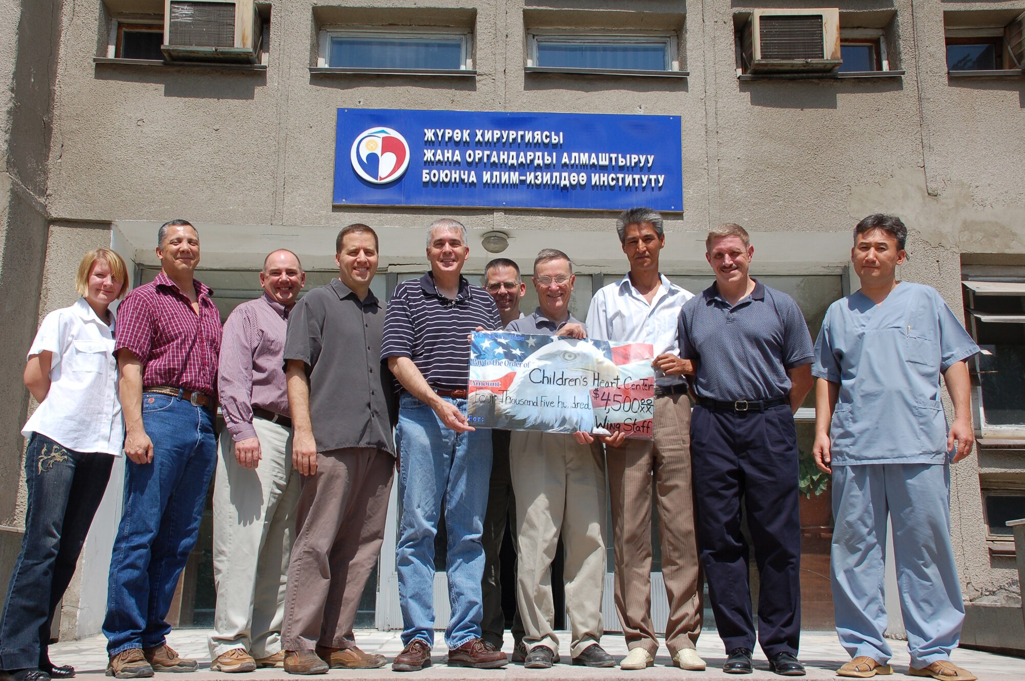 MANAS AIR BASE, KYRGYZ REPUBLIC--Airmen from the Manas AB wing staff agencies present a donation check for $4,500 to Dr. Shabyraliev Esenbekovich, senior cardiac surgeon at the Institution of Cardiac Surgery and Organ Transplantation in the Kyrgyz Republic Capital of Bishkek, Aug. 18. The donation, raised by several dozen Airmen, was the largest single monetary contribution given by the base to the institution, also known as the “Children's Heart Hospital.” Along with another $2,500 donation from the Manas Air Base Outreach Society, the contributions will cover expenses for several surgeons to come to from Moscow to perform life-saving surgeries on ten children. Manas servicemembers’ donations have paid for more than 100 heart surgeries over the past several years. (Air Force photo / Maj. Damien Pickart) 