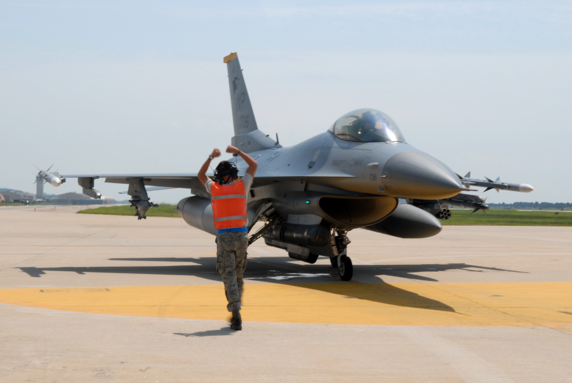 KUNSAN AIR BASE, Republic of Korea -- Senior Airman Jorge Schweitzer, an F-16 crew chief with the 35th Fighter Squadron and Capt. Jesse Protor, an F-16 pilot for 80th Fighter Squadron "Juvats", show some "Juvat" pride after landgin here Aug 20. Following all missions, Kunsan's F-16 Fighting Falcons are dearmed and made safe before returning to the squadron.  (US Air Force Photo By: Senior Airman Angela Ruiz) (US Air Force Photo By: Senior Airman Angela Ruiz)