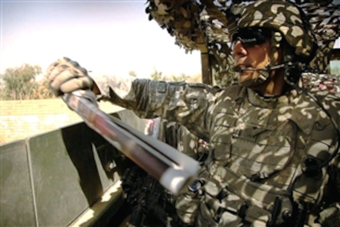 U.S. Army Staff Sgt. J.B. Jaso III throws copies of the Baghdad Now newspaper to residents of Taji, Iraq, from a Stryker armored vehicle, Aug. 16, 2008. Jaso is assigned to the 25th Infantry Division's 1st Battalion, 27th Infantry Regiment. 
