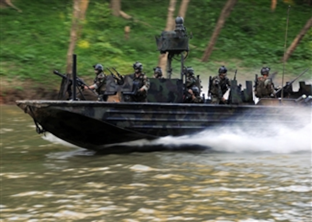 U.S. Navy special warfare combatant-craft crewmen from Special Boat Team 22 conduct live-fire immediate action drills at the riverine training range at Fort Knox, Ky., on Aug. 11, 2008.  Sailors with the unit operate Special Operations Craft-Riverine watercraft and are the only members of U.S. Special Operations Command dedicated to operating in a riverine environment.  