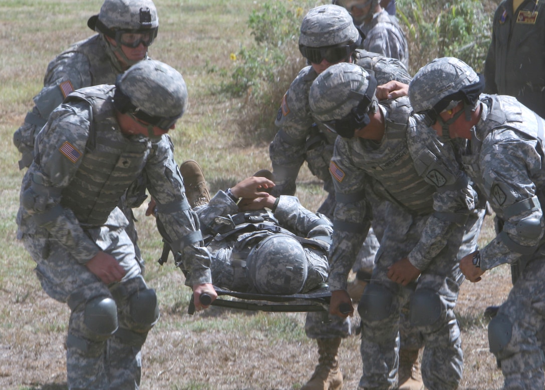 Soldiers with the 545th Transportation Battalion from Hickam Air Force Base prepare to transport one of their fellow soldiers to a waiting SH-60B Seahawk helicopter during a medical evacuation training exercise Aug. 19 at Landing Zone Boondocker. The Army conducted the joint exercise with the help of the Helicopter Anti-Submarine Squadron Light 37 "EasyRiders".