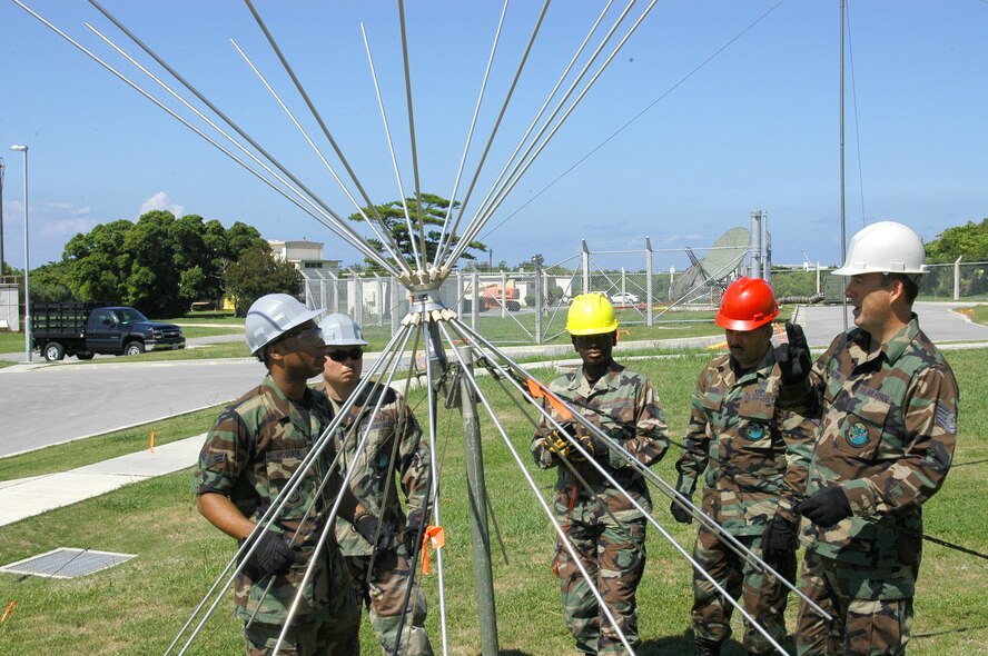 ANDERSEN AIR FORCE BASE, Guam -- Tech. Sgt. Jeff Hamilton (far right), 280th Combat Communications Squadron, asks Airman 1st Class David McQueen (far left), 353rd Operations Support Squadron, a question about setting up an AT-9070 antenna assembly while Tech. Sgt. Francisco Dejesus and Staff Sgts. Alan York and Consylethia Frazier, all with the 280th CBCS, listen in. About 70 people from the 28th CBCS, a traditional Air National Guard unit out of Dothan, Ala., traveled here for two weeks of training with the 353rd OSS. (U.S. Air Force photo/Tech. Sgt. Aaron Cram)