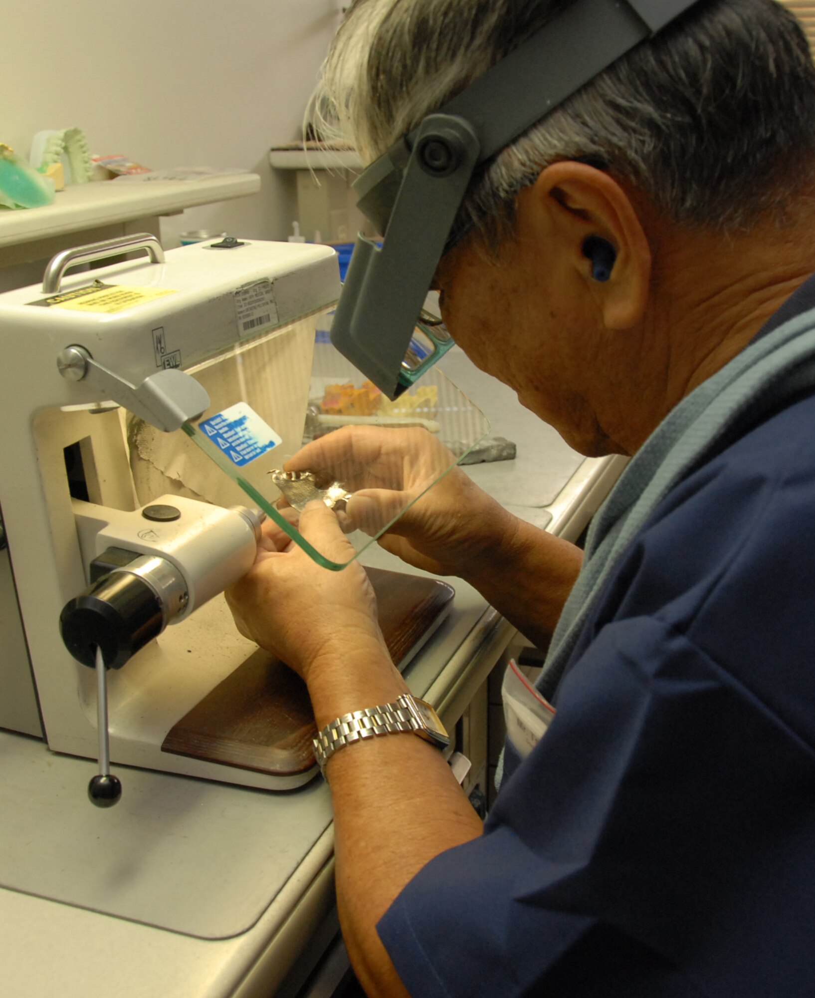 Tsunoda Warren, a dental lab technician with the 18th Wing Dental Squadron Area Dental Lab, polishes a completed metal framework. Both the Area Dental Lab and Base Dental Lab produce a variety of dental prosthodontics including gold crowns, complete dentures, hard night guards, soft or sport mouth guards and retainers.
(U.S. Air Force photo/Airman 1st Class Aaron Johnson)