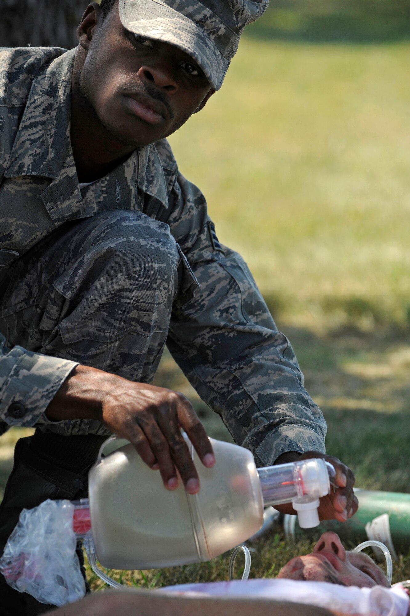 Senior Airman Tim Gross, 28th Medical Group health services management journeyman, simulates providing oxygen to Staff Sgt. Grant Gammons, 28th Logistics Readiness Squadron air transportation journeyman, during a 28 MDG functional exercise here Aug. 21. The exercise consisted of a simulated explosion of hydrogen fluoride. (U.S. Air Force photo/Airman Matthew Flynn)

