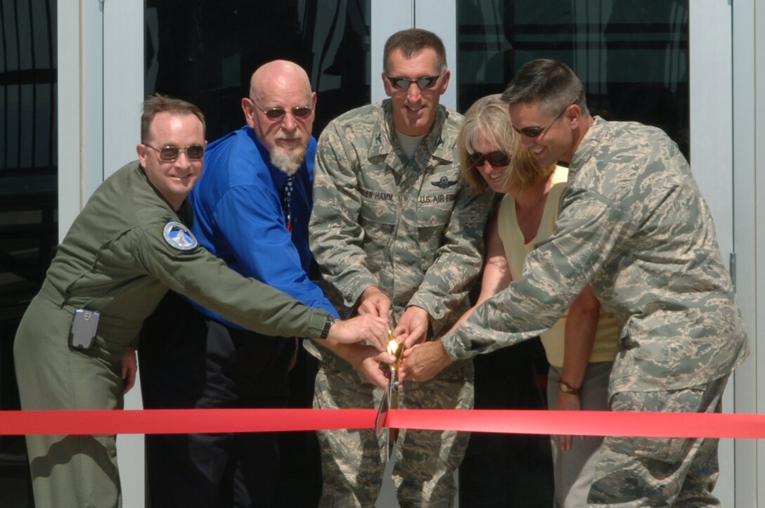 A ribbon cutting ceremony was held for the new Dakota Air Traffic Control Facility here Aug. 20. This facility merges Ellsworth and Minot Air Force Base, N.D., increasing capabilities and efficiencies. The ribbon cutting was done by (from left to right) Col. Kevin Degnan, U.S. Air Force Headquarters Air Force Flight Standards Agency commander, Joe Roberts, Sen. Tim Johnson’s office representative, Col. Scott Vander Hamm, 28th Bomb Wing commander, Kate Kelley, Rep. Stephanie Herseth-Sandlin’s office representative, and Col. Steve Basham, 5th Bomb Wing vice commander. (U.S. Air Force photo/Senior Airman Kasey Zickmund)