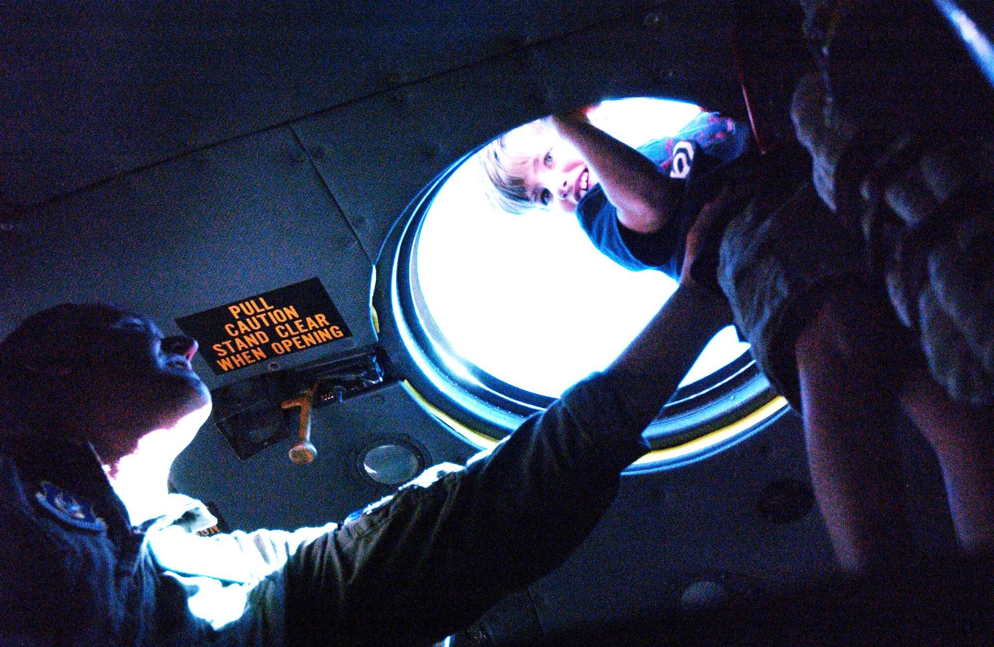 Aircrew members from the 302nd Operations Group, helps Noah Wright, 7, look out the anterior cockpit hatch of a C-130 during a trip of the Big Brothers Big Sisters of Pike's Peak, Inc. Aug. 13, 2008 to the 302nd Airlift Wing, an Air Force Reserve unit at Peterson Air Force Base, Colo. Air Force photo by SSgt. Christian Michael.