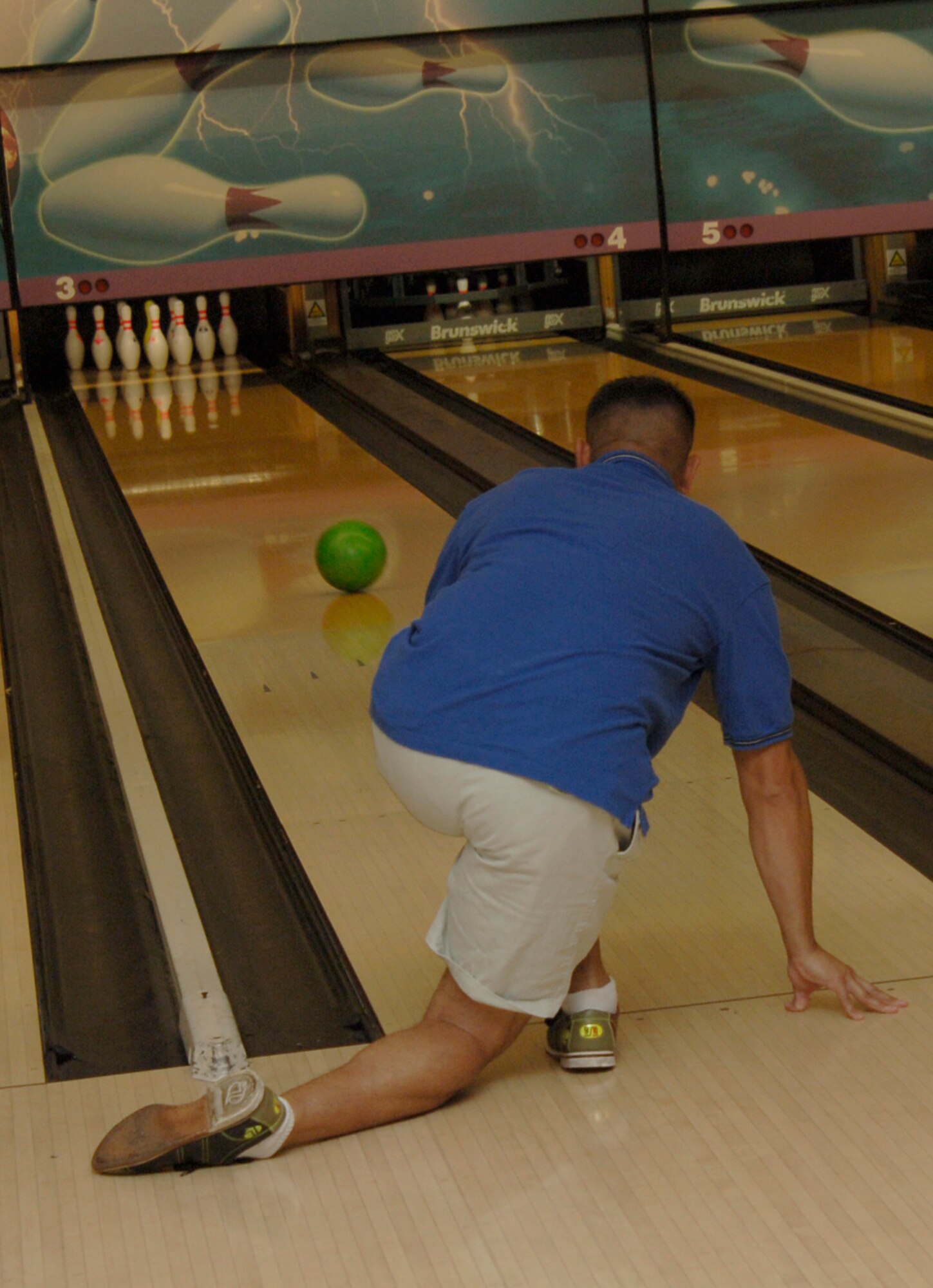 MCCONNELL AIR FORCE BASE, Kan. -- Tech. Sgt. Edgar Salazaraguirre, 22nd Air Refueling Wing protocol office, waits to see how many pins he knocks down during the Air Force Ball Bowling Fundraiser at the Robert J. Dole Community Center, Aug. 15. The bowling fundraiser raised $1550.10 for the Air Force Ball. (Photo by Senior Airman Roy Lynch III)