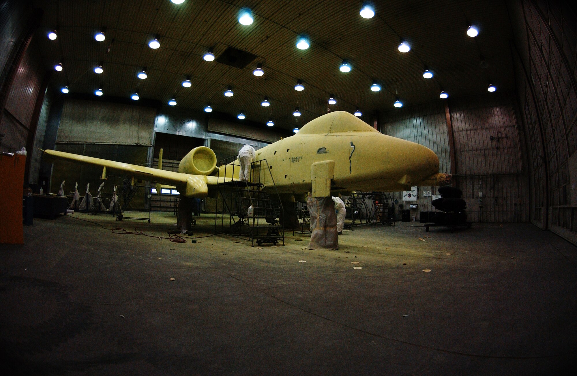 Airman 1st Class Timothy Coulson, left, and Airman Daniel Peters, right, sand down the primer on an A-10 Thunderbolt II preparing it for its first base coat of paint Aug 20, 2008 at Eielson Air Force Base, Alaska. 354th Maintenance Squadron fabrication shop Airmen are working on restoring an A-10 static display from Heritage Park. This aircraft will forever be a reminder of the 355th Fighter Squadron presence here before they were deactivated in 2007.  (U.S. Air Force photo by Airman 1st Class Jonathan Snyder)