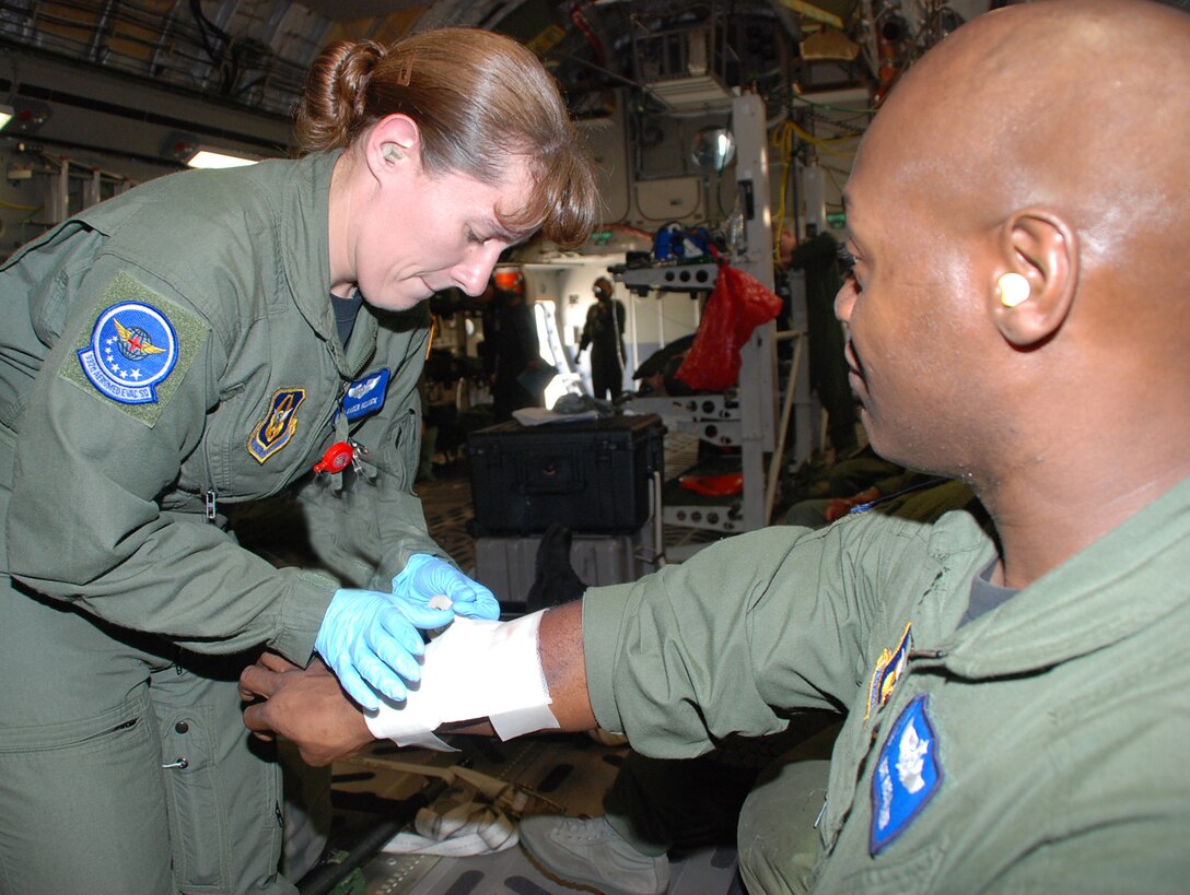 A 932nd Aeromedical Evacuation Squadron crew member takes care of her "patient" during a training event at the AE Jamboree 2008 held at Scott Air Force Base.  The crew went on a C-17 flight to train for several hours.  Photo by Tech. Sgt. Danny Oliver