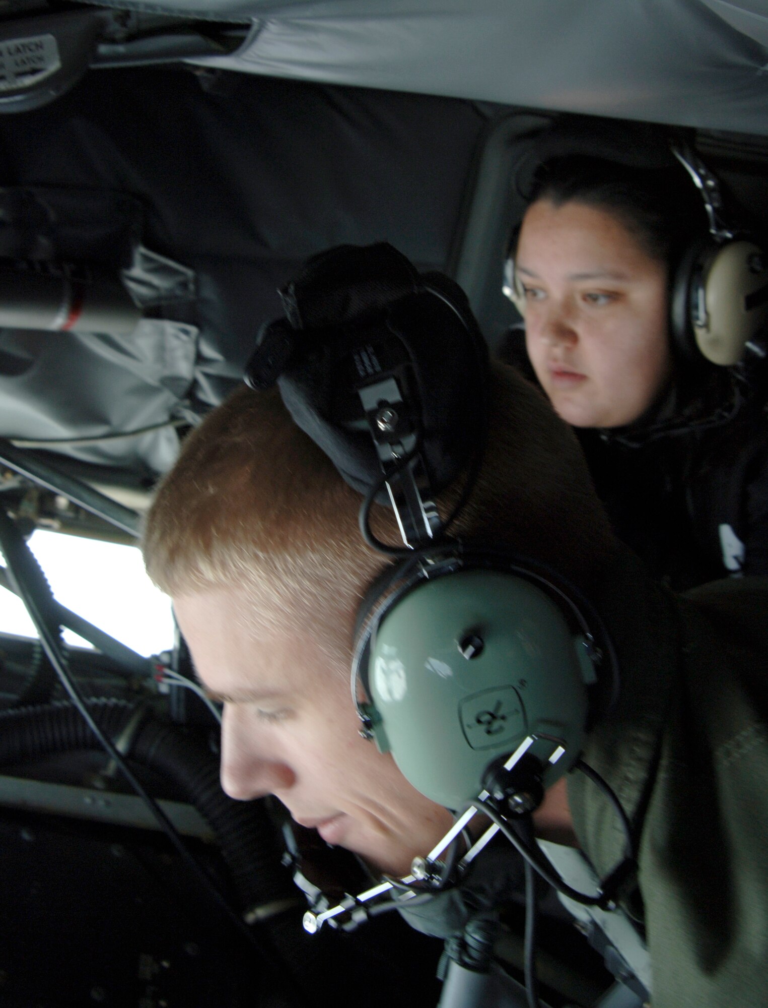 MCCONNELL AIR FORCE BASE, Kan. -- Bernadette Cisneros-Frank, wife of Staff Sgt. Buck Frank, 22nd Operation Support Squadron, watches Airman 1st Class Andrew Kueffler, 384th Air Refueling Squadron, refuel another KC-135 Stratotanker during the 384th ARS Spouse Orientation Flight, Aug. 16. Team McConnell spouses were able to see first hand the aerial refueling mission and capability of McConnell Air Force Base. (Photo by Senior Airman Roy Lynch III)