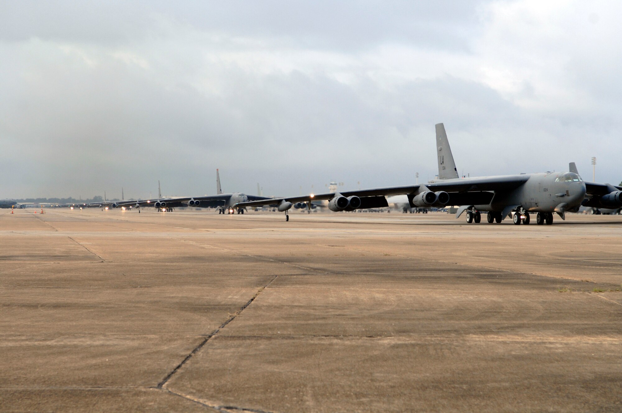 The 2nd Bomb Wing demonstrates runway saturation capability using a minimal interval take off, or MITO, launching 13 B-52s in minimum time, under adverse weather conditions. This is part of their Nuclear Operational Readiness Exercise. (U.S. Air Force photo by Airman 1st Class Brittany Y. Bateman)