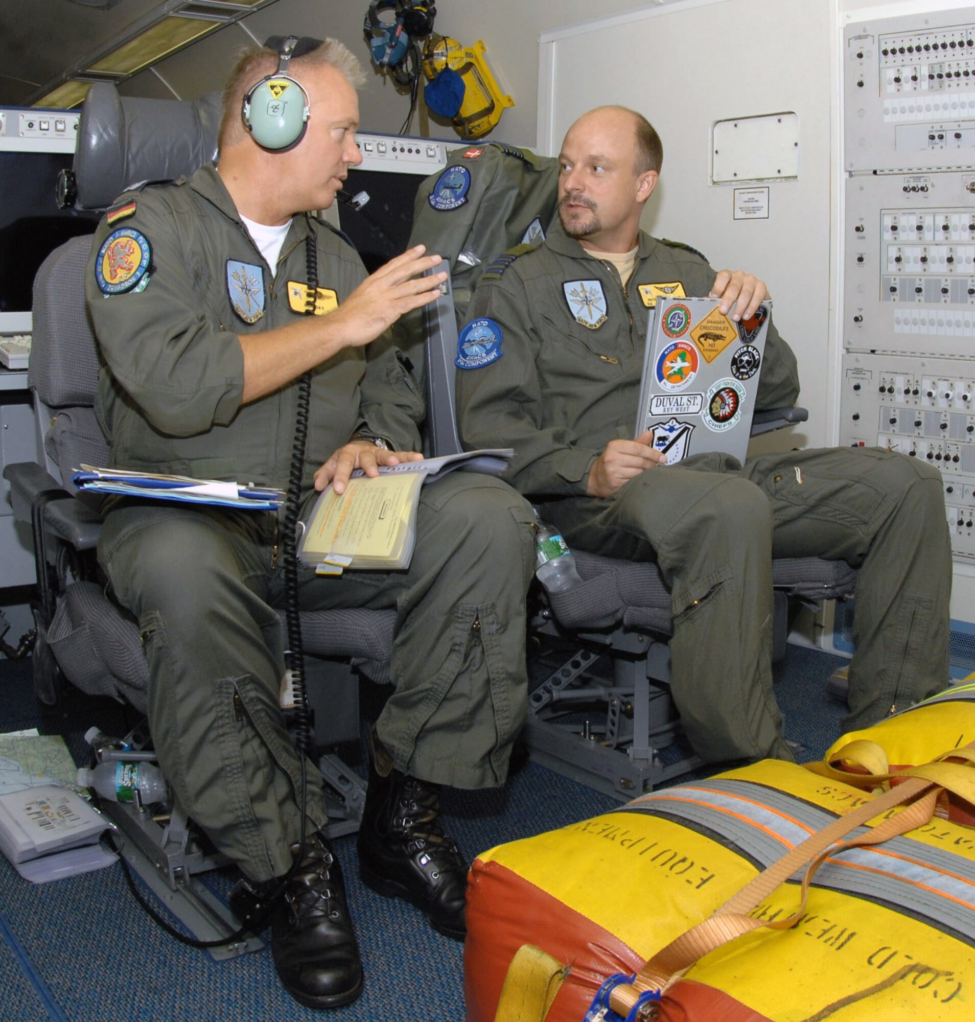 German Lt. Col. Raimond Schulz and Danish Maj. Peter Boersting discuss preflight procedures on a NATO E-3A Sentinel, an airborne warning and control systems aircraft Aug. 15 at Seymour Johnson Air Force Base, N.C. On the aircraft there are Airmen from Turkey, Portugal, United States, Denmark, Germany, Greece and Canada. (U.S. Air Force photo/Airman 1st Class Gino Reyes)