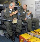 German Lt. Col. Raimond Schulz and Danish Maj. Peter Boersting discuss preflight procedures on a NATO E-3A Sentinel, an airborne warning and control systems aircraft Aug. 15 at Seymour Johnson Air Force Base, N.C. On the aircraft there are Airmen from Turkey, Portugal, United States, Denmark, Germany, Greece and Canada. (U.S. Air Force photo/Airman 1st Class Gino Reyes)