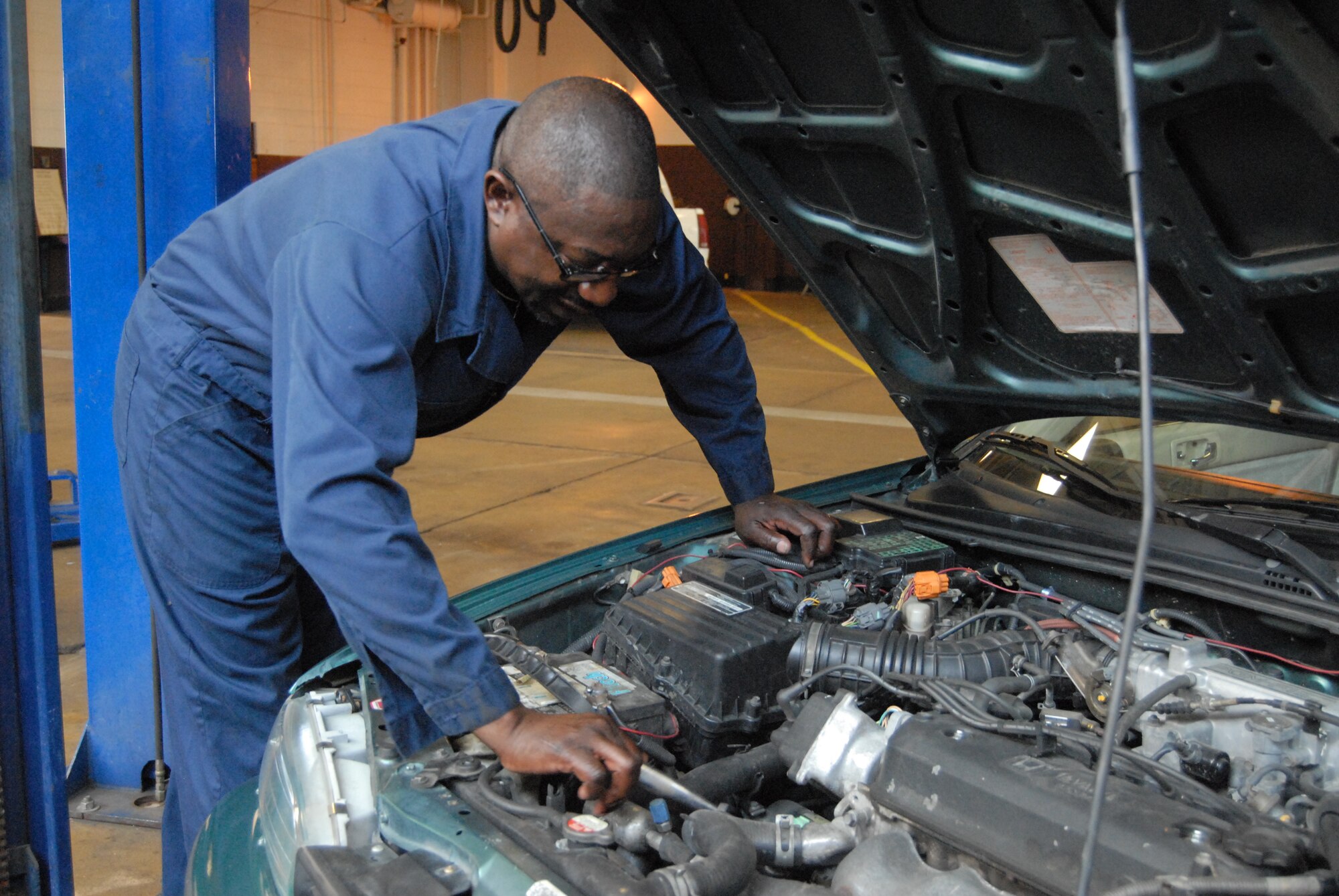 Richard Burns, 440th Airlift Wing safety manager, performs a "Good Lookin' Out" vehicle inspection at Pope's Auto Hobby Shop as part of the 101 Critical Days of Summer. Mr Burns is an Automotive Service Excellence certified mechanic and performs free safety inspections every Wednesday from 1 to 4 p.m. through Aug. 27.