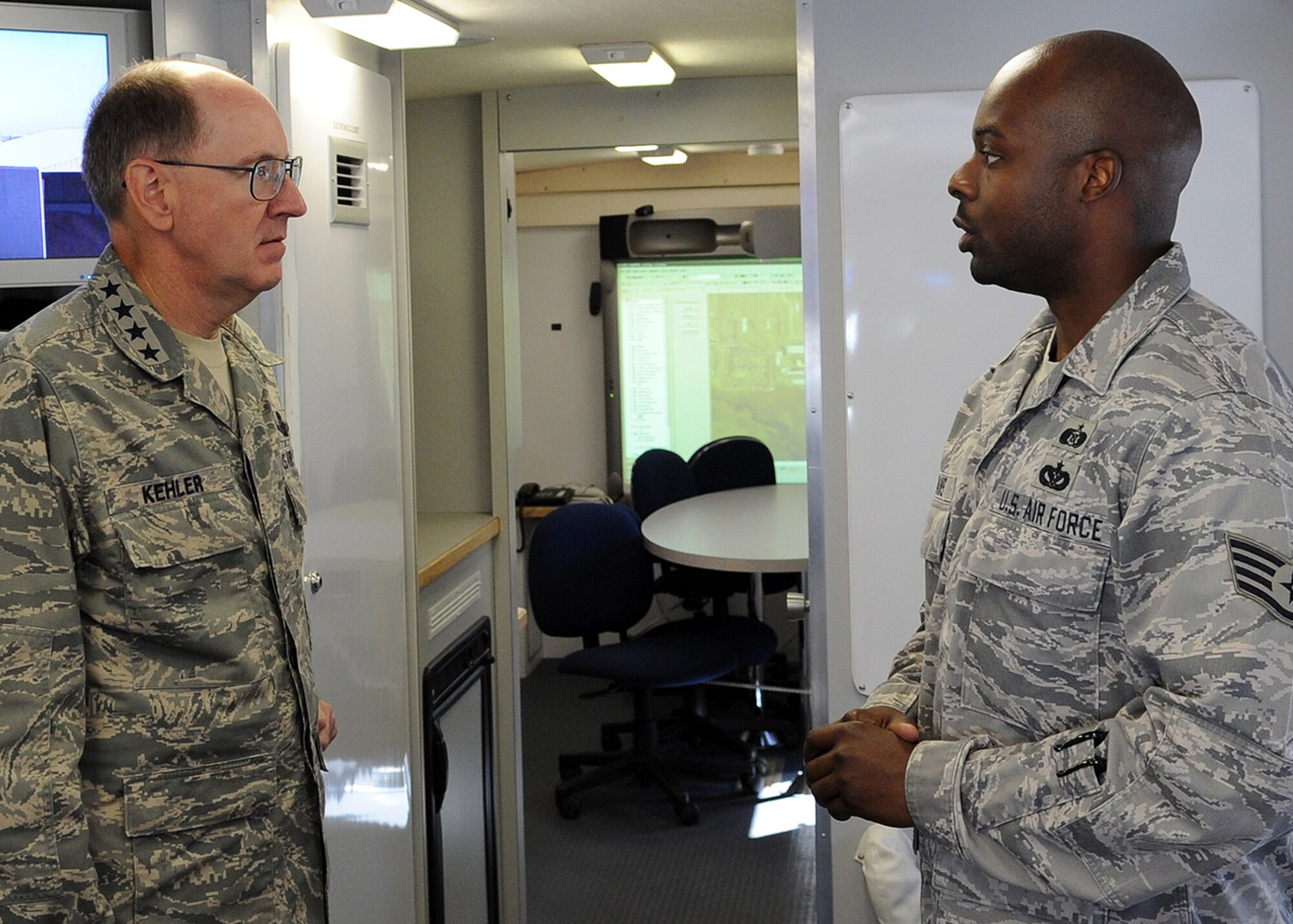 BUCKLEY AIR FORCE BASE, Colo. -- Staff Sgt. Othniel Evans, 460th Civil Engineer Squadron, informs Gen. C. Robert Kehler, Air Force Space Command commander, of the capabilities of the Mobile Emergency Operations Center during a tour of the vehicle. General Kehler spent Aug. 19 and 20 on the base visiting work centers for the first time since taking command of AFSPC in October 2007. (U.S. Air Force photo by Senior Airman Steven Czyz)