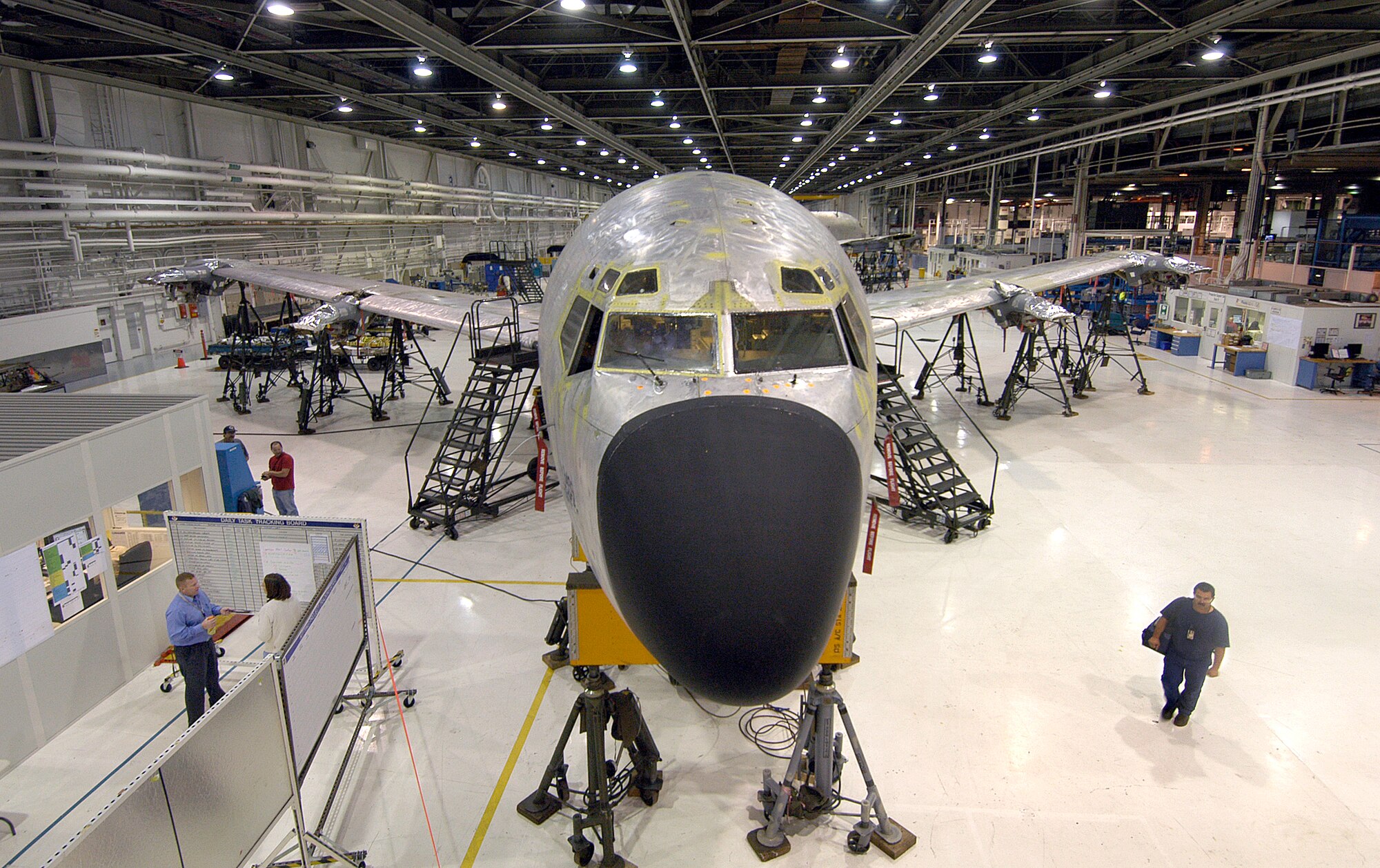 A KC-135 undergoes depot maintenance in Bldg. 3001, an area many remember as cluttered and dark before terms like Lean, 6S and transformation were commonly heard terms.   Teams gather in newly created areas throughout Bldg. 3001 shops to continue the transformation process throughout the center. (Air Force photo/Margo Wright)
