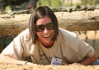 8/14/2008 - Lorena Hernandez, Lackland Elementary, low crawls her way through the tactical course during Teachers Understanding Deployment Operations Aug. 14. TUDOS gave educators the opportunity to learn about the deployment process. (USAF photo by Robbin Cresswell)