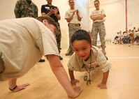 8/14/2008 - Jeremy Alvarez, 4, demonstrates impressive upper-body strength during the pre-deployment portion of Operation JET, or Junior Expeditionary Team, Aug. 14. Operation JET gave Team Lackland children the opportunity to participate in a mock deployment and learn about what their parents go through when they deploy. (USAF photo by Robbin Cresswell)