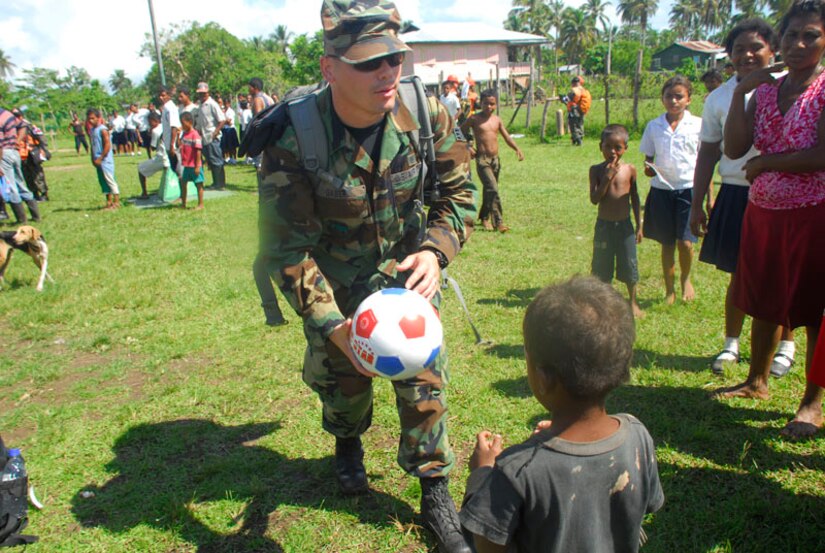 CLUBKI, Honduras - Senior Airman Josh Gabert, Joint Task Force-Bravo Medical Element, gives a soccer ball as a gift from MEDEL to the children in Clubki. Airman Gabert is part of multi-national team that is participating in medical readiness exercise here. The exercise gave free medical care to more than 300 people here. (U.S. Air Force photo by Staff Sgt. Joel Mease)