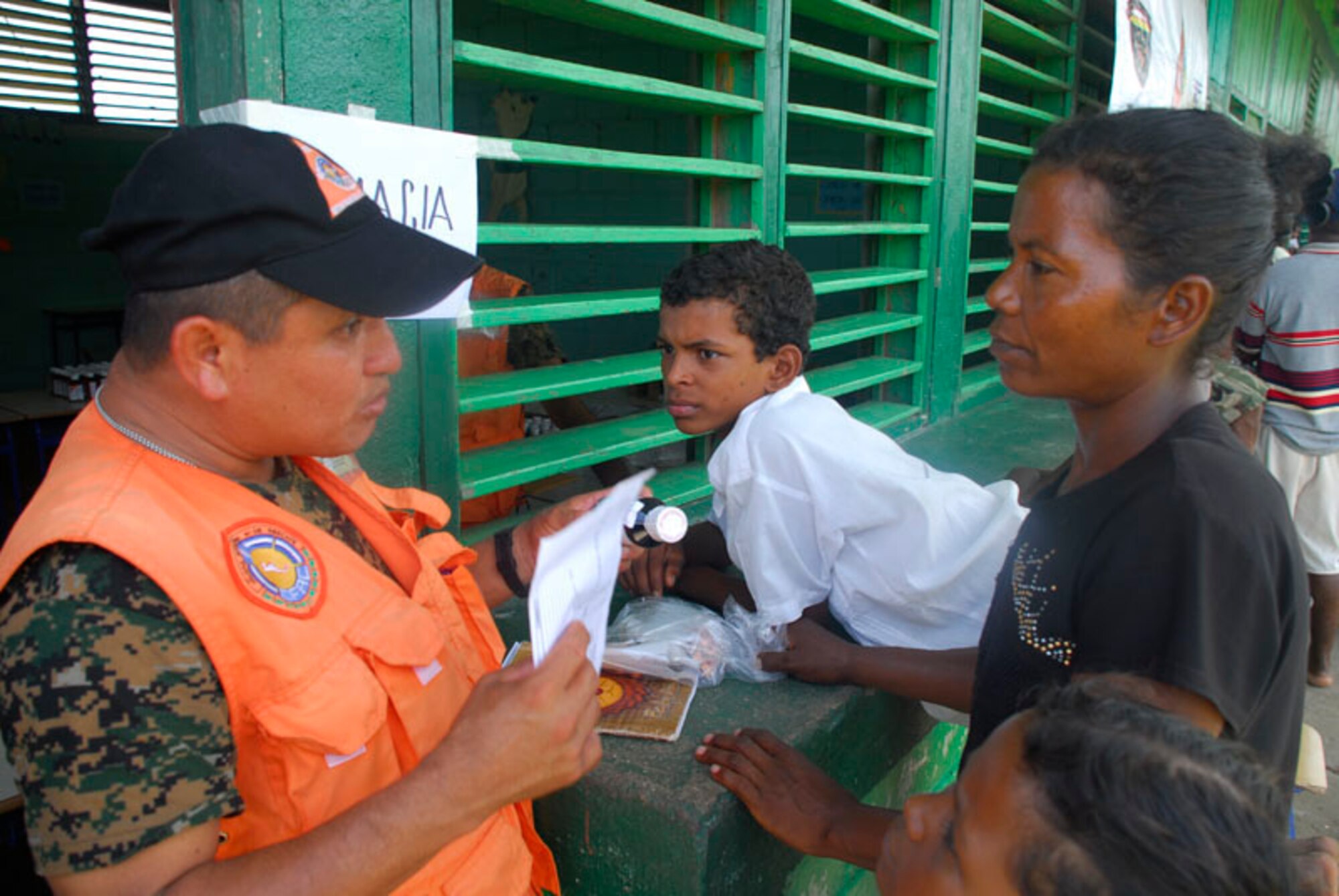CLUBKI, Honduras - A medical professional from the Central American team hands out pharmacy products to the people here Aug. 19. Countries that participated in the medical exercise include Honduras, El Salvador, Guatemala, and the United States. (U.S. Air Force photo by Staff Sgt. Joel Mease)