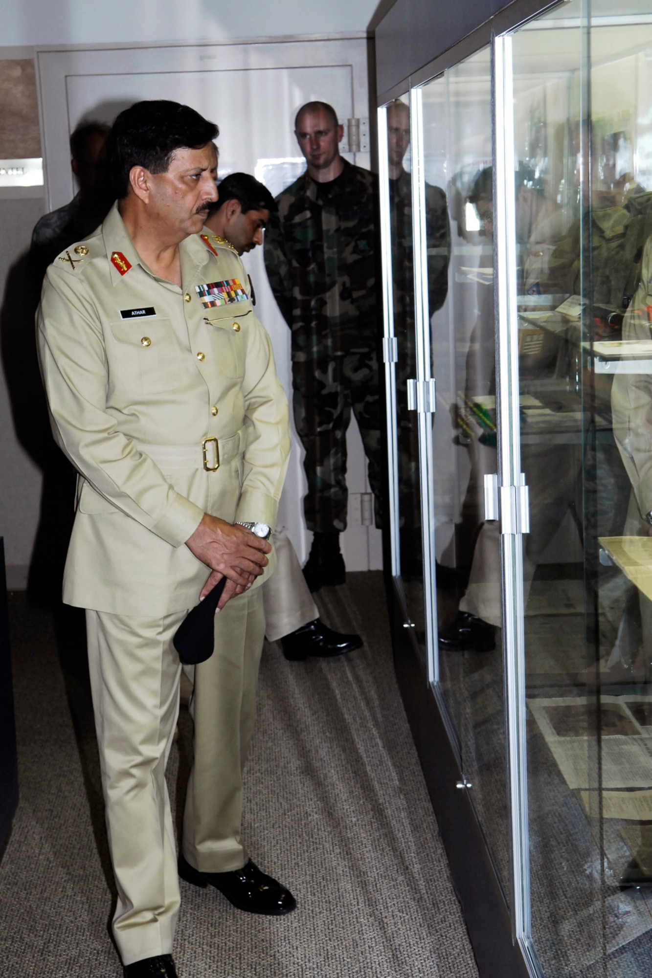 Lt. Gen. Syed Athar Ali, Vice Chairman of Defense for the Islamic Republic of Pakistan, looks at the displays in the 18th Air Support Operations Group’s Heritage Hall Aug. 5 during his tour of Pope.  (U.S. Air Force Photo by Mike Murchison)