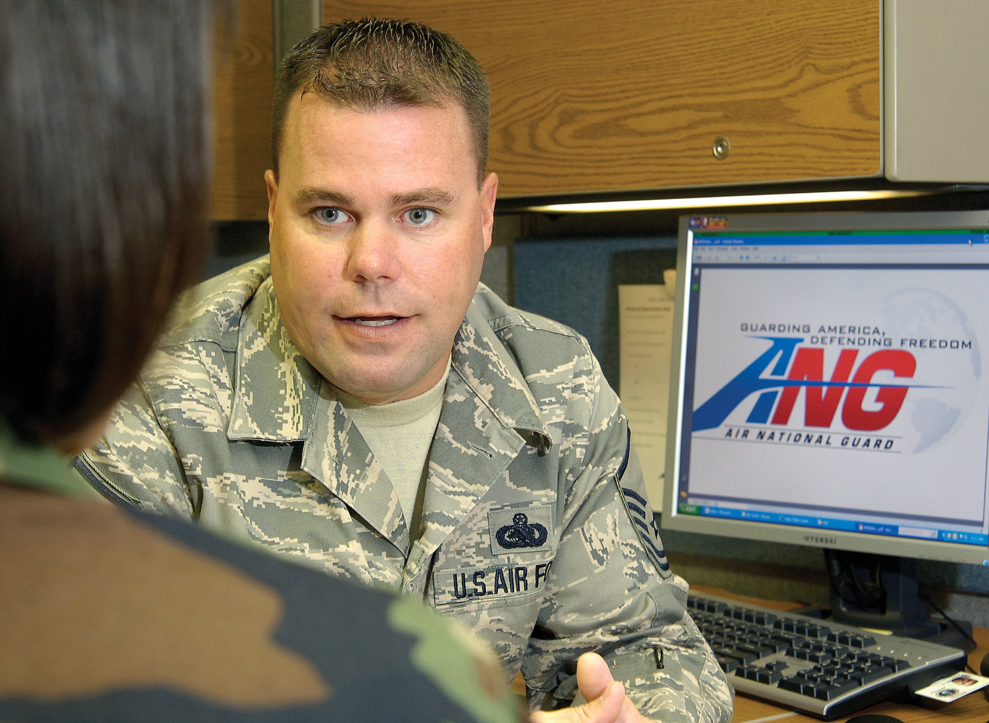Air National Guard recruiter Master Sgt. TImmothy Tanner talks about the benefits of the Guard with an active duty Air Force member recently.  Sergeant Tanner is located in Bldg. 460.(Air Force photo/Margo Wright)  

