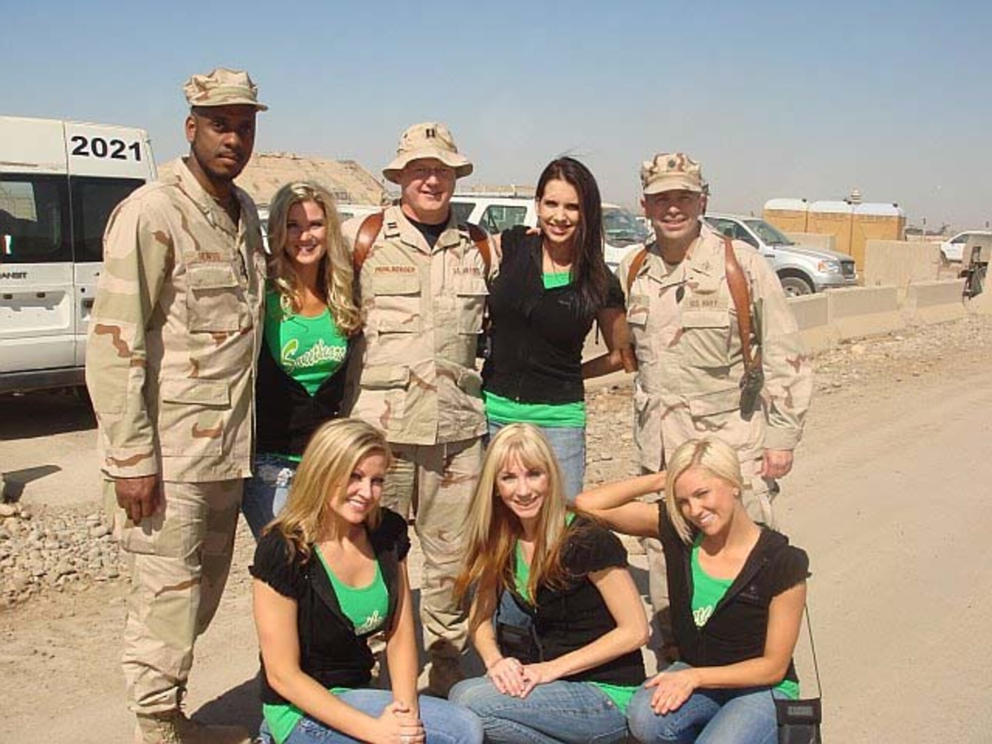 BALAD, Iraq -- (Top row, second from right) Former Senior Airman Jessica Andrews, 459th Aeromedical Staging Squadron, joins deployed troops and fellow "Sweetheart for Soldiers" members here during a 10-day visit to Iraq and Kuwait last fall. Sweethearts for Soldiers is a group of former NFL cheerleaders with a special connection to the military. The group puts together a military themed calendar each year to send to the troops with care packages. (Courtesy photo)