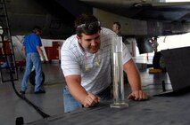 Ryan Mead checks the density of the SJ-8 50/50 blended synthetic fuel before use in two successful F-15 Strike Eagle flight tests Aug. 19. Mr. Mead is an F-15 fuels engineer at Warner Robins Air Logistics Center, Robins Air Force Base, Ga. (U.S. Air Force photo/Claude Lazzara) 