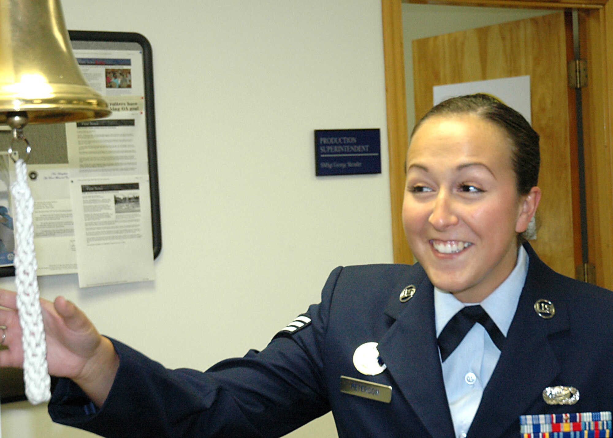 Senior Airman Kari Peterson, New Hampshire Air National Guard, rang the squadron bell Aug. 13, signifying the 319th Recruiting Squadron made recruitment goal for 40 consecutive months. Airman Peterson is augmenting the squadron in Portsmouth, N.H. She and her active-duty teammates earned an outstanding rating on the unit Air Education Training Command Inspector General inspection Aug. 10-15, the first of such Force Recruiting Service achievements in four years. (U.S. Air Force photo/Senior Master Sgt Robert Barrett)
