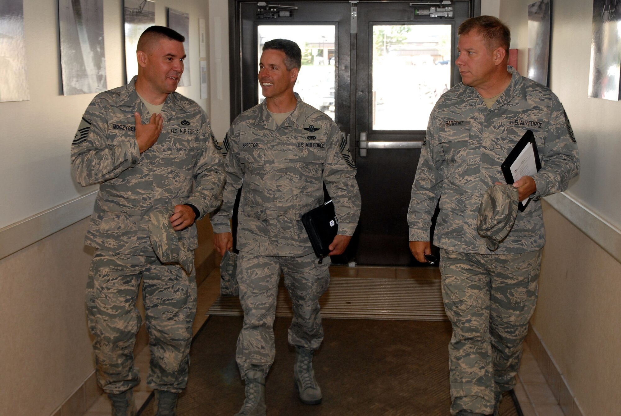 Master Sgt. Albert Mocyygemba, Central Dorm Management Officer, escorts Chief Master Sgt. David Spector, 20th Air Force command chief (center) and Chief Master Sgt. Steve Sargent, 341st Missile Wing command chief, into dormitory 1082 prior to a tour of the facility Aug. 14.  Chief Spector accompanied Maj. Gen. Roger Burg, 20th AF commander, on a visit to Malmstrom for the inactivation of the 564th Missile Squadron Aug. 15. (U.S. Air Force photo/John Turner)