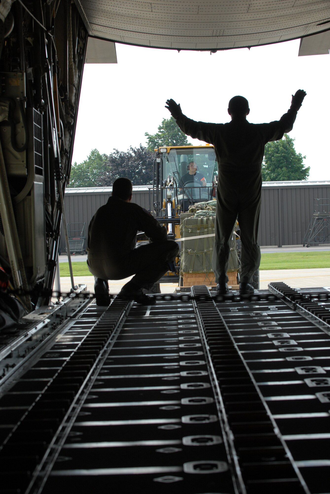 Members of the 179th Ariel Port Squadron load cargo into C-130 aircraft at Mansfield Lahm Airport, Mansfield, Ohio on July 9, 2008. The Ariel Port Airman are supporting an Air Rodeo competition where pilots display their skills in air drops and landing precision. (Air Force photo by Staff Sgt Robert Koehler) (Released)
