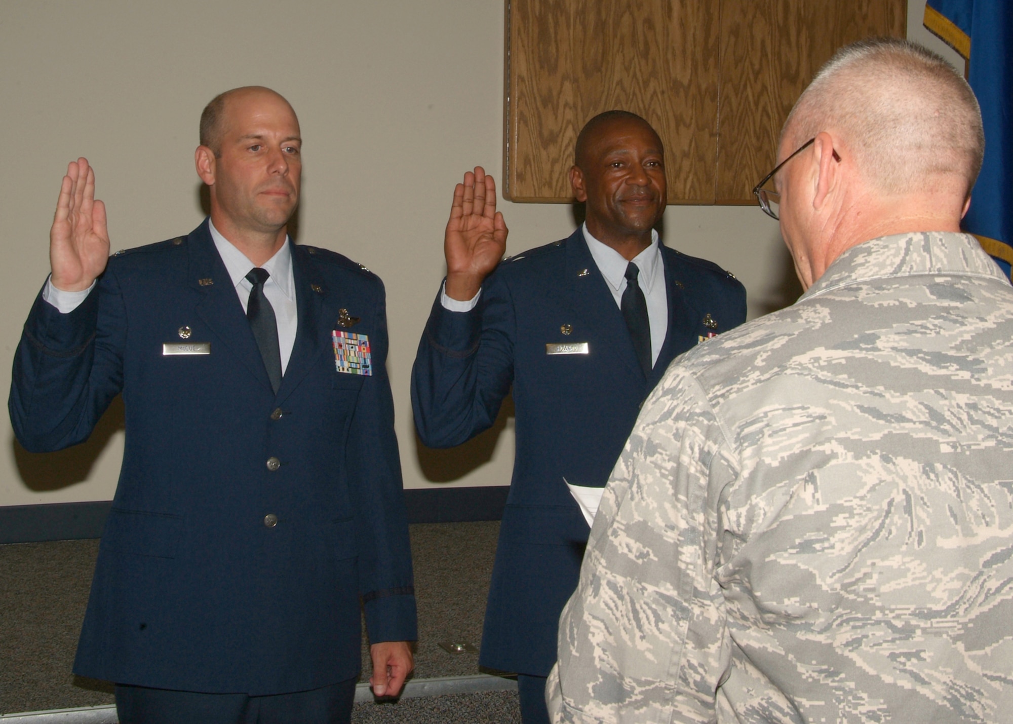 National Guard Bureau's Colonel Jeff Lewis administers the oath to newly promoted Colonels Michael Howard (right) and Gary McCue at the 179th Airlift Wing, Mansfield Ohio. Col Michael Howard is the first black Colonel at this Air National Guard base.  (U.S. Air Force photo by Technical Sgt. Lisa Haun) (Released)
